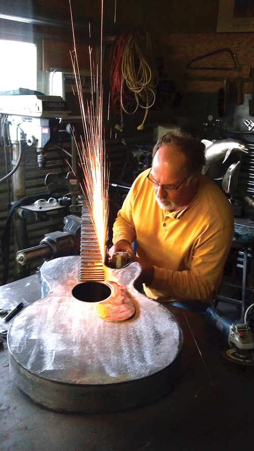 Author Dale Evers working on a metal sculpture.