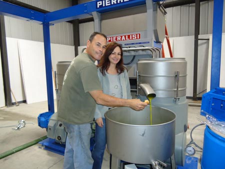 Owners making olive oil