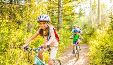 girl riding bike through forest